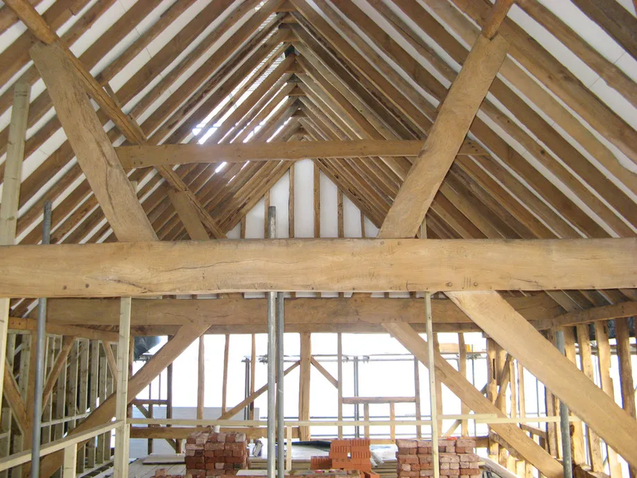 a large wooden structure with a roof made of wood beams
